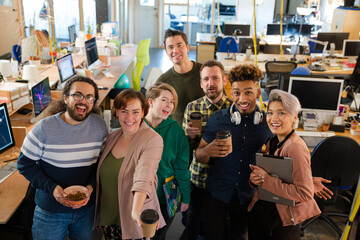 Team posing in office, smiling