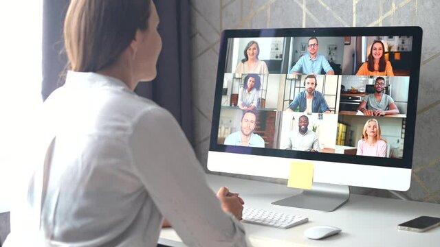 Woman using app for distance video communication with coworkers, friends, meeting online, looking and waving at laptop desktop with people profiles. Video meeting