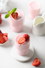 Strawberry lassi or milkshake on a white background with copy space. Close up. Healthy ayurveda...