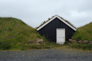 Flat hut between two piles of earth in Iceland