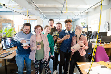 Obraz premium Team posing in office, smiling