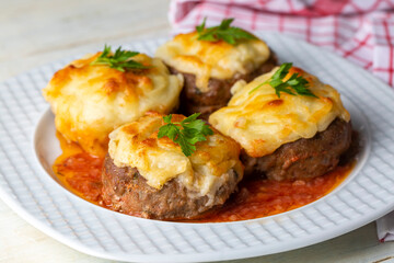 Turkish Food Hasanpasa Kofte - Kofta with Puree - Meatball with Bechamel Sauce and Green Peas. Traditional Food.