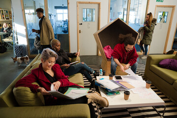 Man and woman reviewing paperwork in cosy office