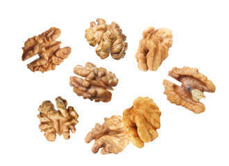 Halves of walnuts falling on white background