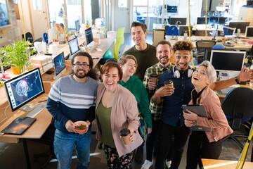 Team posing in office, smiling