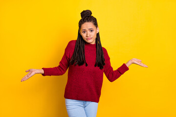 Photo of sweet upset dark skin lady wear red pullover shrugging shoulders isolated yellow color...