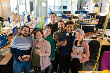 Team posing in office, smiling