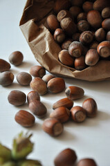 Hazelnut close-up. Hazelnuts in a paper bag on a wooden background. Hazelnut background, healthy food. Corylus. 