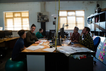 Colleagues working in open plan office