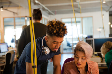 Man and woman discussing paperwork in office