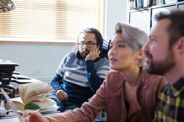 Colleagues working at computer in office