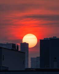 Vibrant hazy sunrise as the sun comes up from behind high rise buildings. Toronto Ontario. 