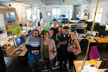 Team posing in office, smiling