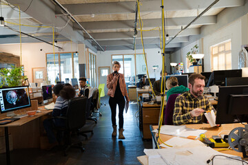 People working in open plan office