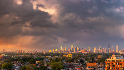 Colorful sunset illuminating storm clouds over the downtown Toronto skyline in Ontario Canada
