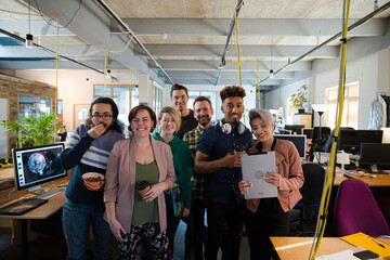 Team posing in office, smiling
