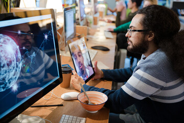 Young man using tablet computer at desk