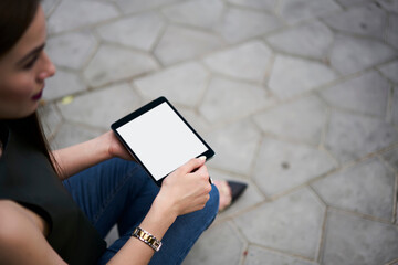 Blurred female blogger using modern touch pad technology with copy space area for advertising text, cropped woman browsing networks website via mockup digital tablet with blank touchscreen