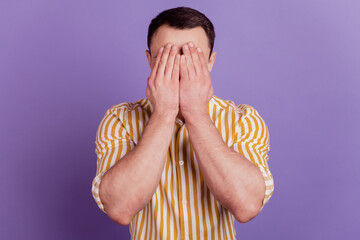 Portrait of desperate crying guy hands hide face wear casual clothes on violet background