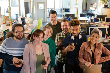 Team posing in office, smiling