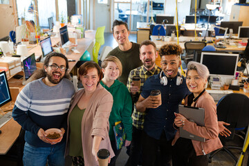 Team posing in office, smiling