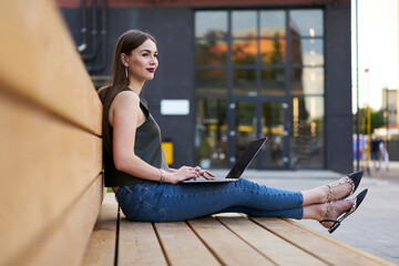 Pensive female freelancer thoughtful looking away during time for doing distance job on modern...
