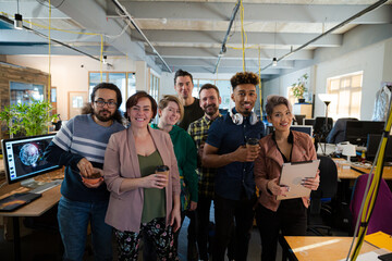 Team posing in office, smiling