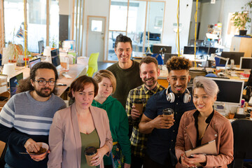 Team posing in office, smiling