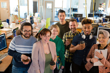 Team posing in office, smiling
