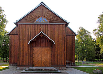 General view and architectural details of the belfry and the wooden Catholic church of St. Andrew...
