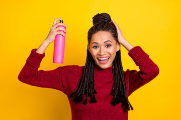 Photo of funny pretty dark skin lady wear red pullover applying hair spray arm head isolated yellow color background
