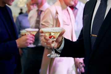 bride and groom holding champagne glasses