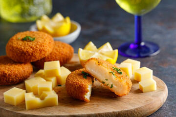 Homemade cheese croquettes. A delicious starter homemade cheese croquettes with a piece of lemon on the side.