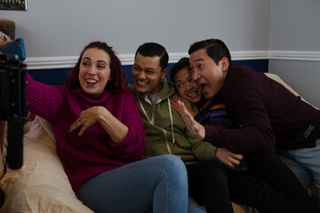 Happy friends taking a break from moving, taking selfie on sofa