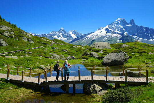Idyllic landscape with Mont Blanc mountain range in sunny day. Hikers on trip in the Nature Reserve Aiguilles Rouges, French Alps, France, Europe.