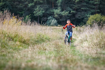 A Happy child cycling in the park concept in nature