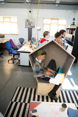 Fototapeta premium Young man working at laptop in modern armchair
