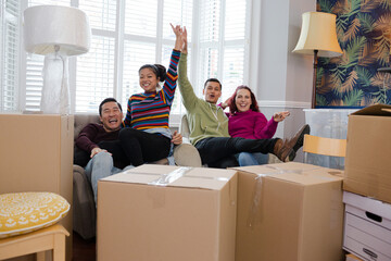 Friends taking a break from moving, relaxing in living room