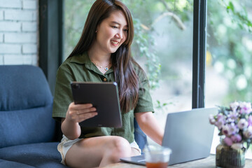 Happy of asian freelance people business female casual working with laptop computer and using tablet with coffee cup and smartphone in coffee shop like the background,communication concept