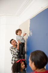 Happy family painting wall