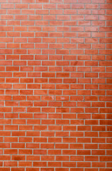 vertical Background texture of brownish orange brick wall