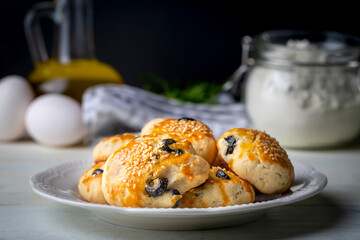 Turkish style pastry with olives and dill cheese pastry (Turkish name; Zeytinli pogaca ve dere otlu peynirli pogaca)