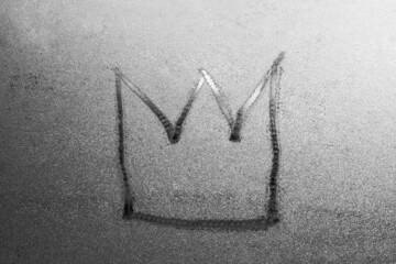 crown isolated on gray misted glass background. Emperor treasure. Close up covid symbol