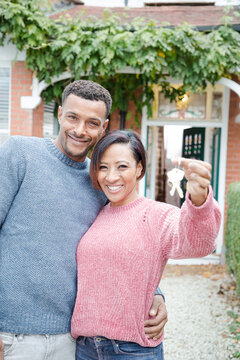 Portrait couple with keys to new house