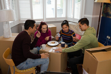 Friends taking a break from moving, playing cards
