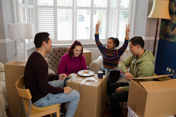 Friends taking a break from moving, playing cards