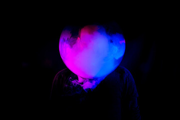 Conceptual image about pollution and global warming. photograph on black background with smoke and neon colors.