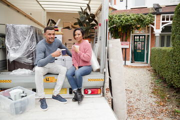 Couple talking at back of moving van