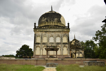 Antique Islamic Architectural Art Pointed Arches Seven Tombs Dome and Blue Sky Green Trees