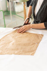 Obraz premium A seamstress cuts a pattern